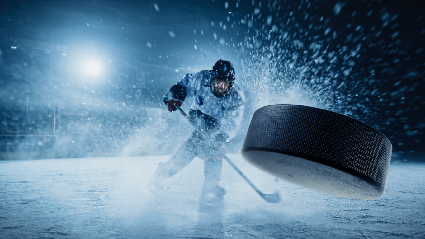 Closeup of hockey puck flying into net in ice hockey arena. BetMGM Sportsbook PA is offering valuable promos on one-game parlays, $1000 welcome bonus, and more, with extra value for NBA & NHL playoffs games.