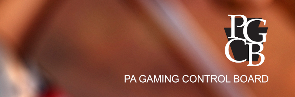 Pennsylvania Gaming Control Board (PGCB) logo is seen on blurred abstract orange and brown background. The PGCB just released a report analyzing PA gambling behaviors in 2021.