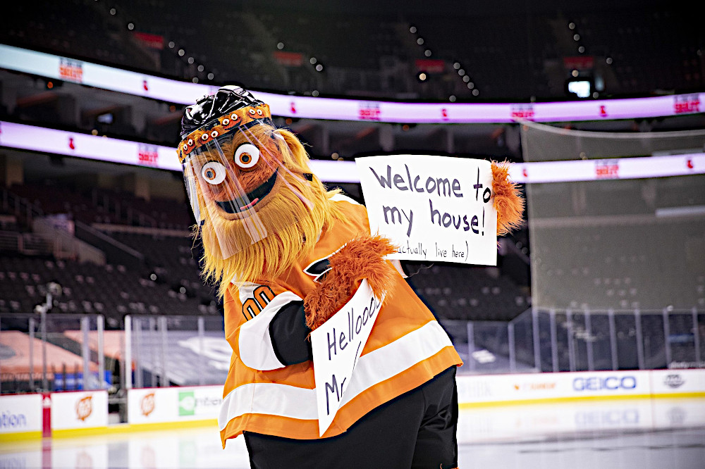 Gritty, the orange NHL Flyer's team mascot, is seen standing on the ice holding a paper sign that says "Welcome to My House" as if he is welcoming PointsBet, PA's newest sportsbook to town.