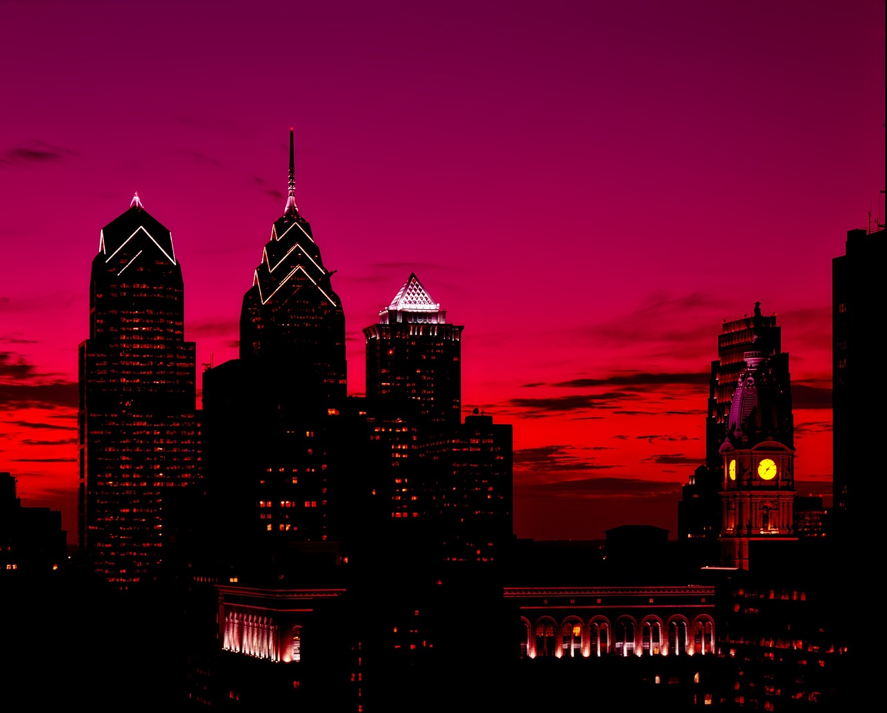 silhouettes of philadelphia skyscrapers seen against a sunset sky. 
